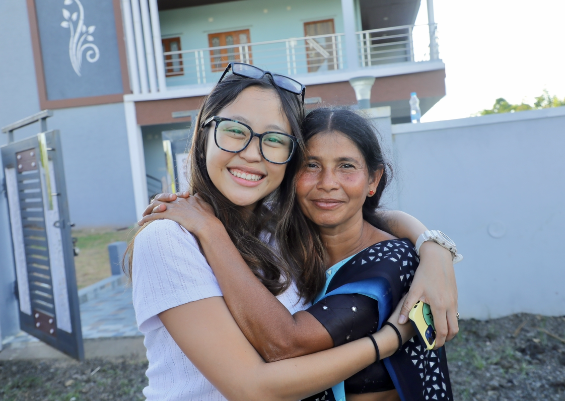 Team member embracing a local woman outside the ministry house