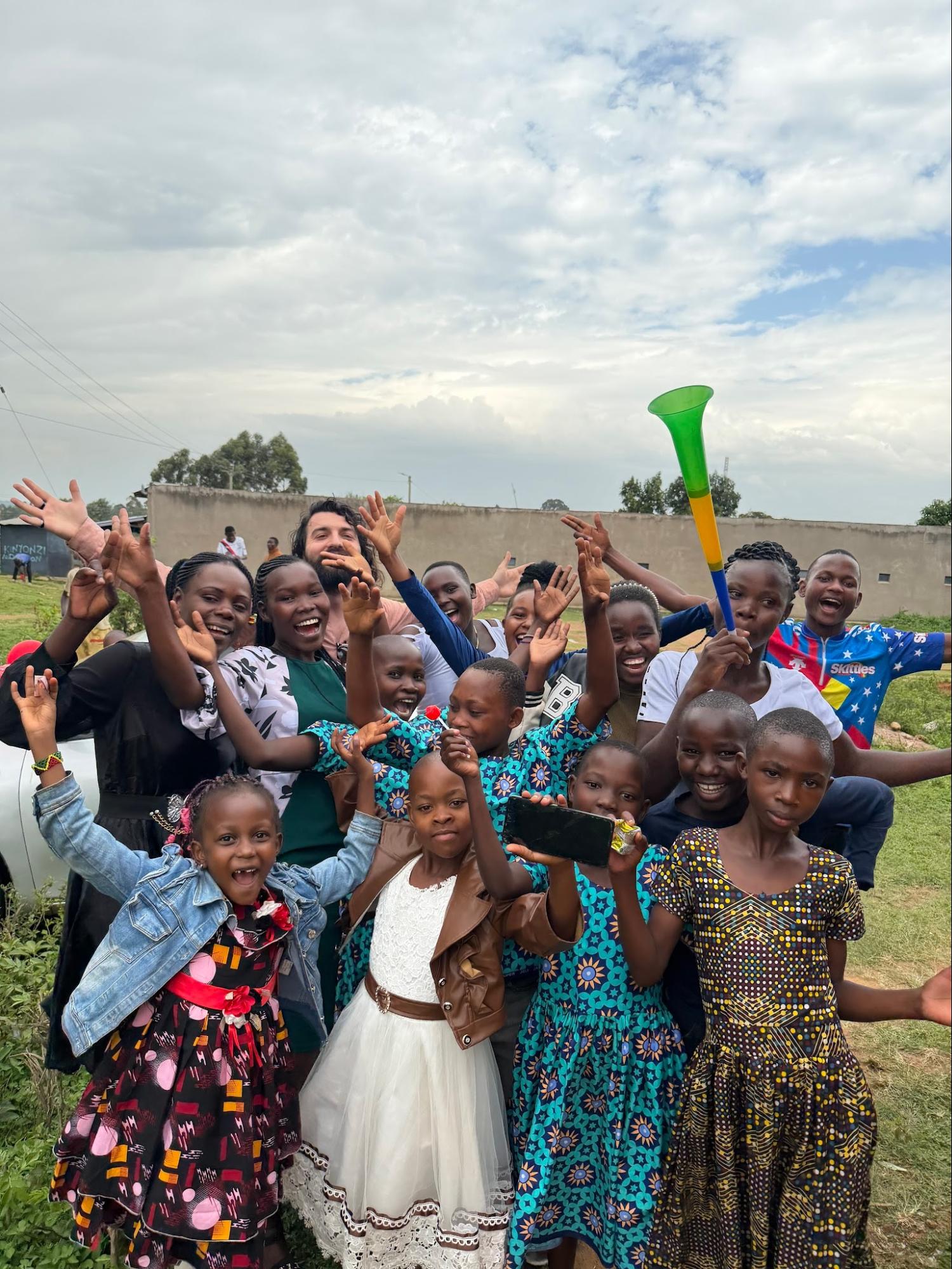 Joyful crowd of children and women celebrating together outdoors