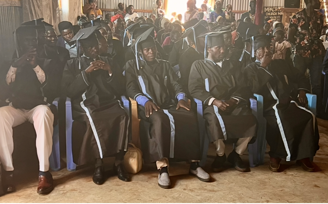 Ministry school graduates seated in caps and gowns