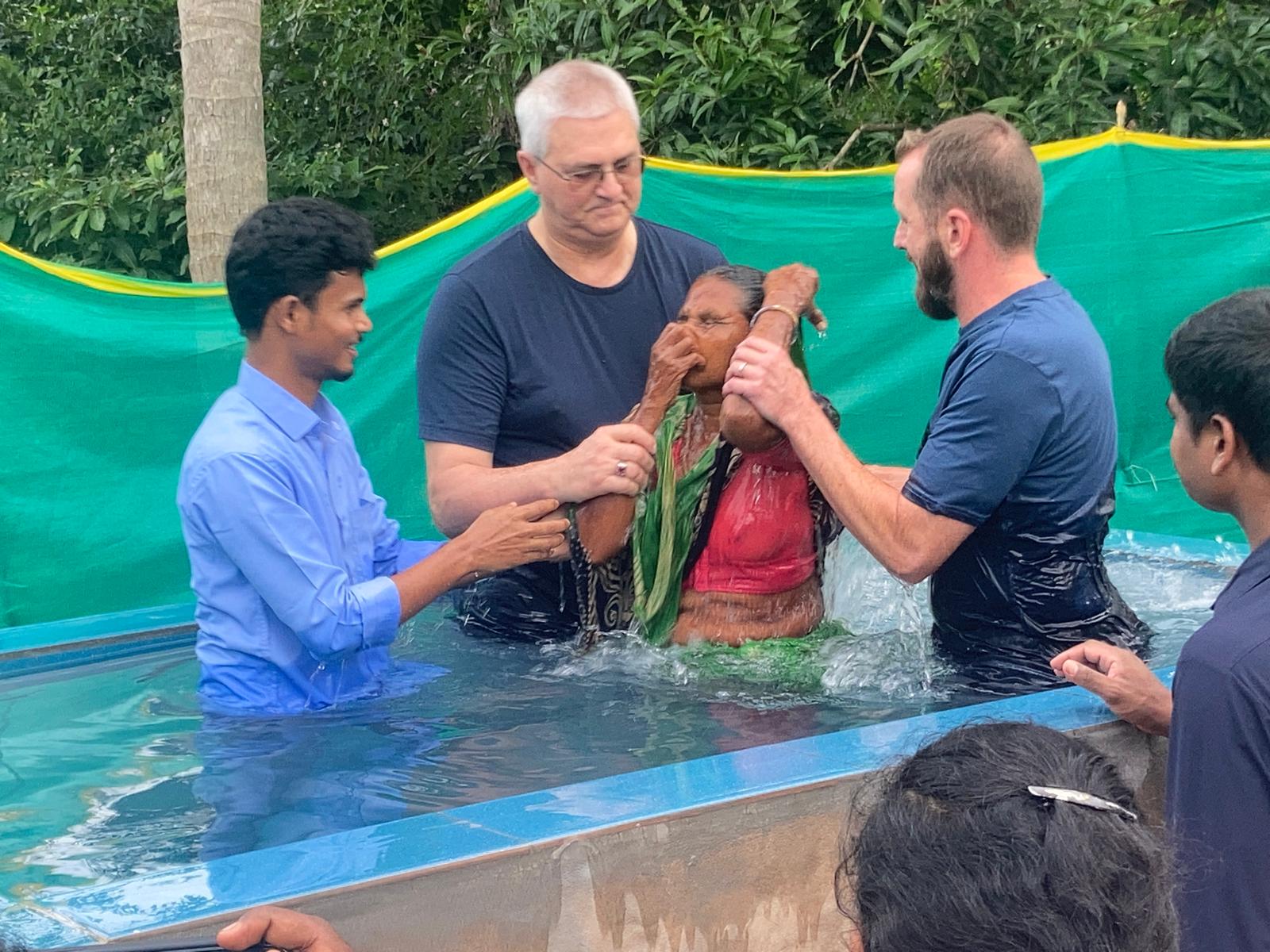 Baptism of a new believer in an outdoor baptismal pool