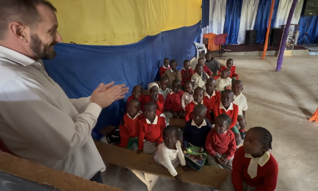 Team member teaching a class of young students