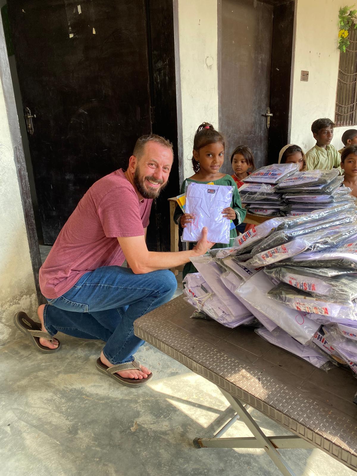 A student receiving new school supplies in Pakistan