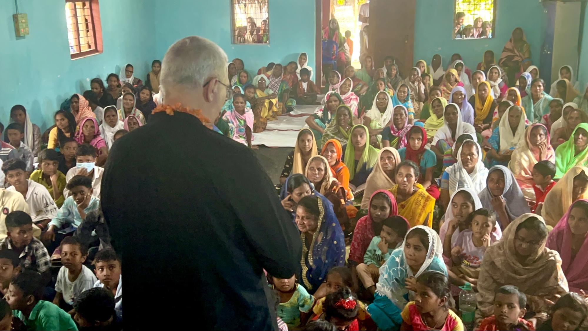 Teaching a full room of women and children in the village church
