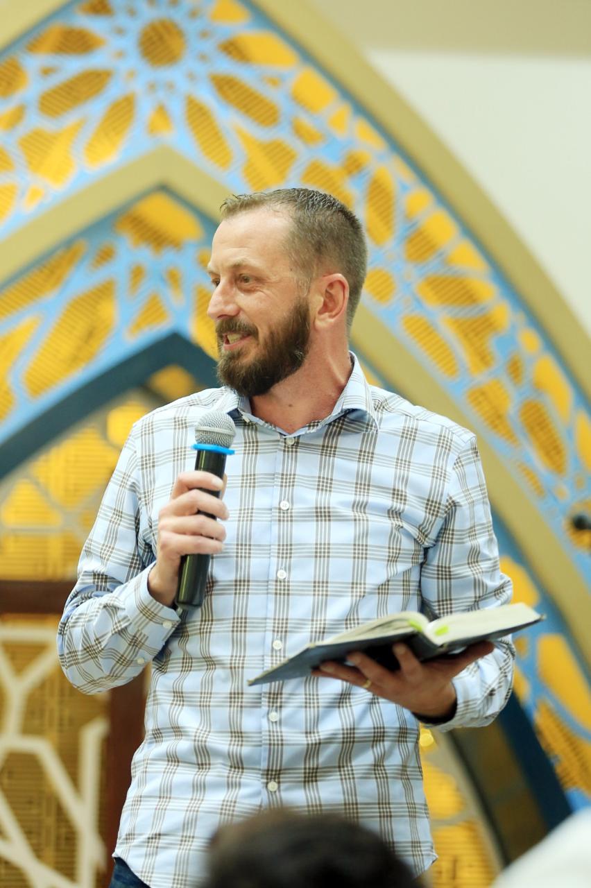 A ministry leader teaching from the Bible in Pakistan