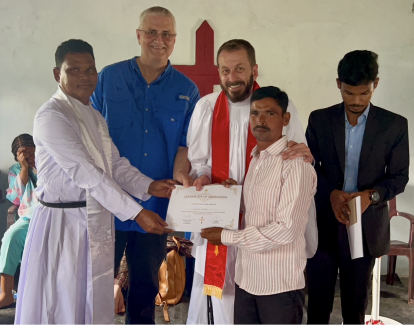 Pastor receiving his certificate of ordination