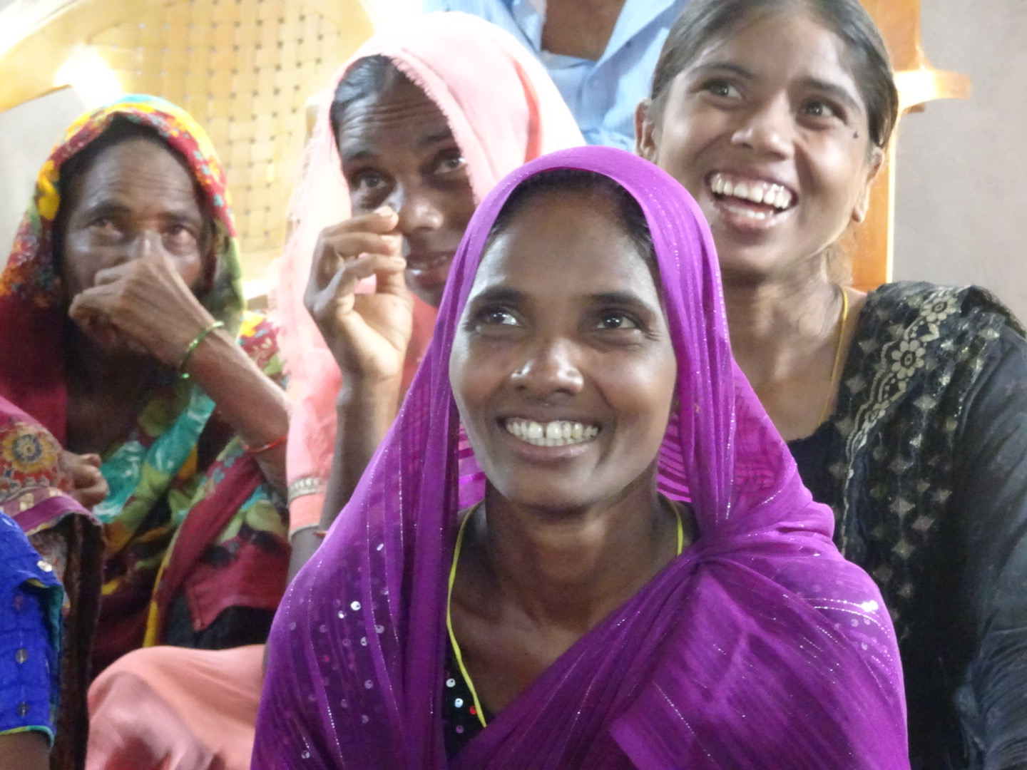 Women smiling joyfully during a gathering