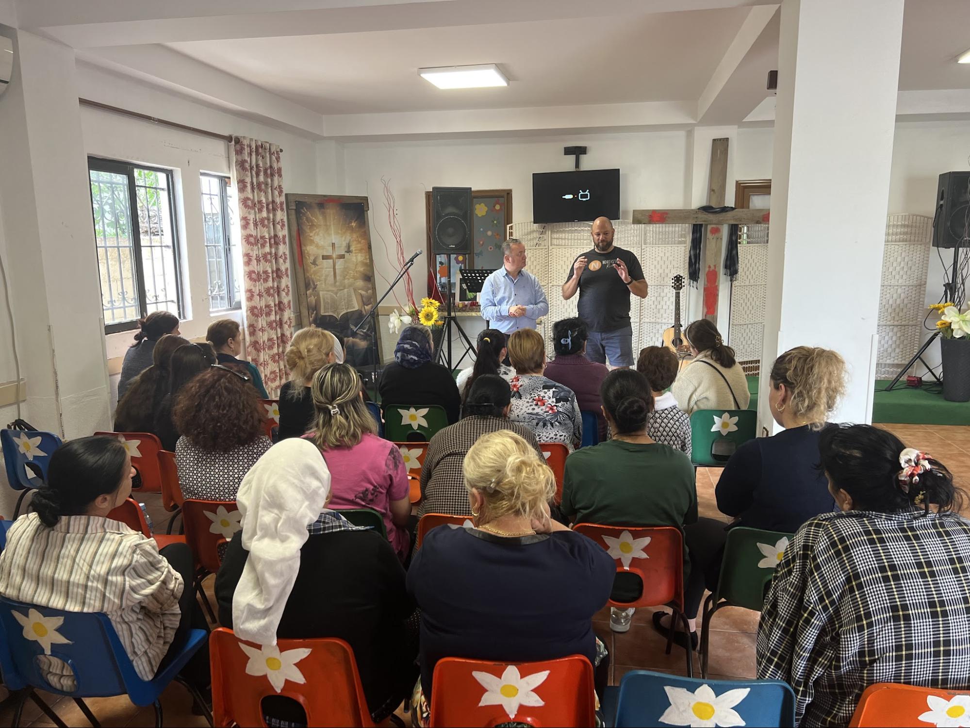Speakers teaching a room of women at a local church gathering