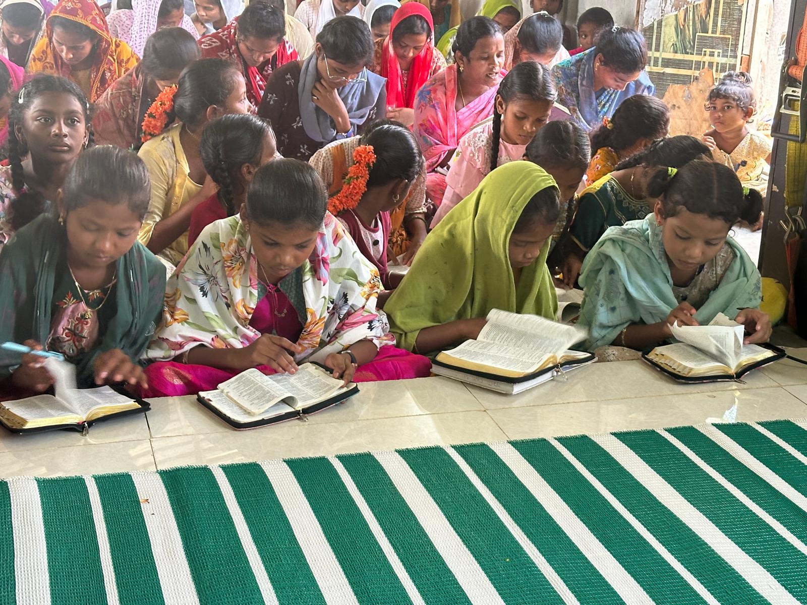Girls and women studying open Bibles together