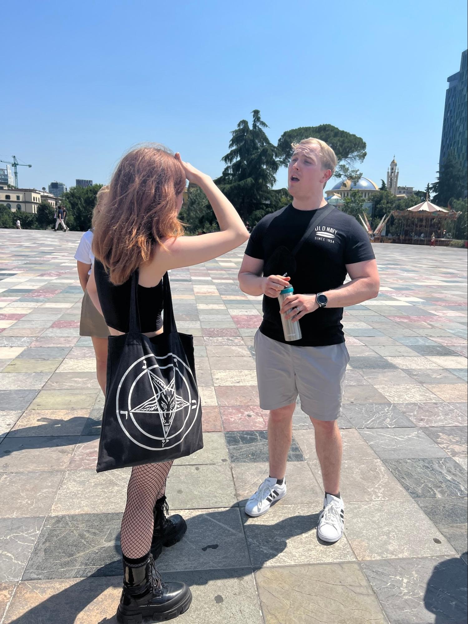Believer sharing Christ with a young woman in a city square